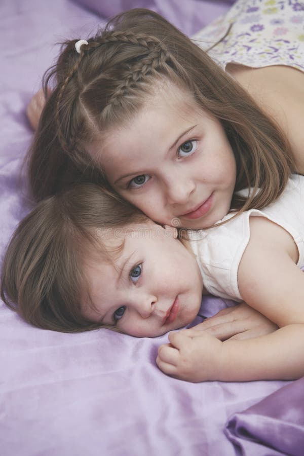 Children Girls On The Bed In A Skirts Of Tulle Like A Fairies Stock