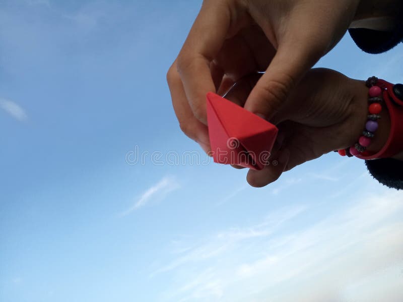 Children hands hold paper ships with blue sky background. Team work and togetherness concept. stock images Children hands hold paper ships with blue sky background. Team work and togetherness concept. stock images
