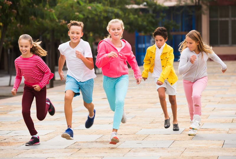 Children jogging in park stock image. Image of cute - 193935985