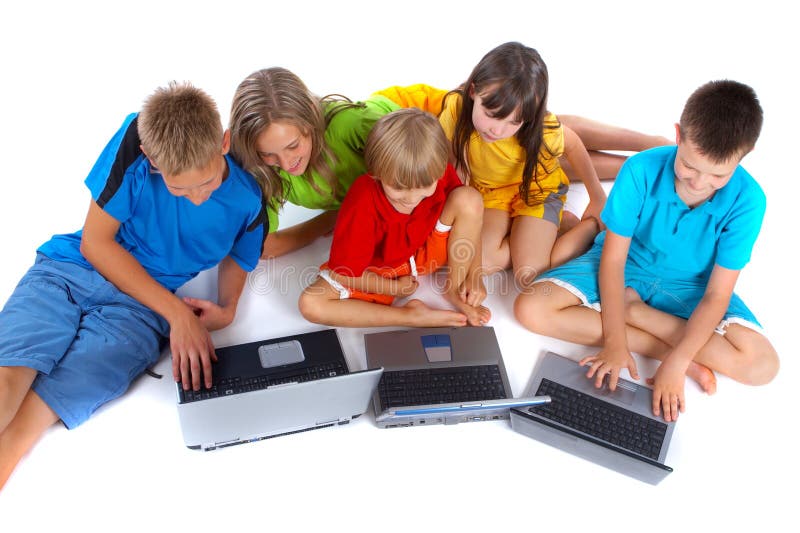 Cinque bambini, seduti in un semi-cerchio sul pavimento, guardando tre computer portatili di fronte a loro.