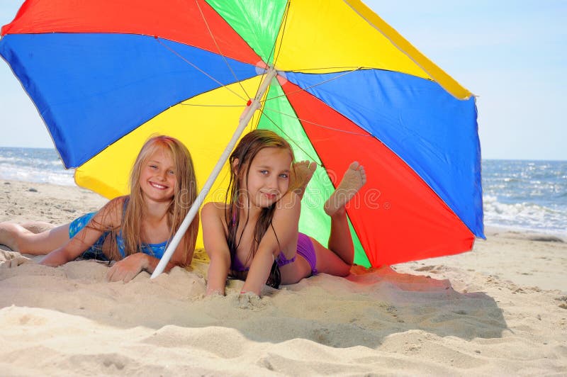 Children laying on beach stock photo. Image of pool, play 24386000