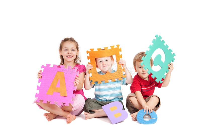 Three kids having fun learning with alphabet ABC letters. Isolated on white. Three kids having fun learning with alphabet ABC letters. Isolated on white.