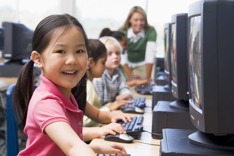 Kindergarten children learning how to use computers.