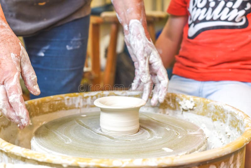 Children Making Pottery during Ceramic Lesson with Clay Stock Photo