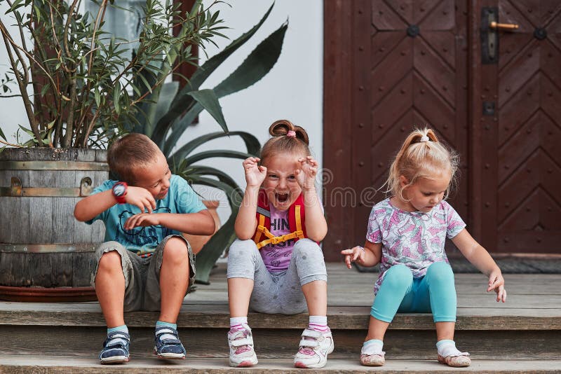 Children making silly faces. Kids having fun showing goofy poses posing to camera