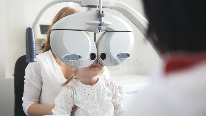 Children ophthalmology - optometrist Checks Eye of little girl stock image Children ophthalmology - optometrist Checks Eye of little girl stock image