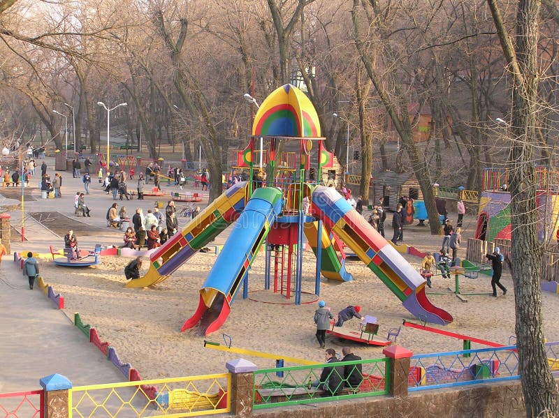 Children play the child's ground in a municipal park, spring, Dnepropetrovsk, Ukraine. Children play the child's ground in a municipal park, spring, Dnepropetrovsk, Ukraine