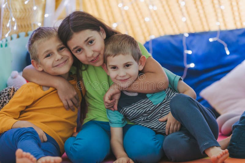 Children play at home with pillows and covered blanket royalty free stock image