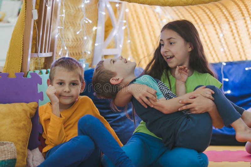 Children play at home with pillows and covered blanket royalty free stock images