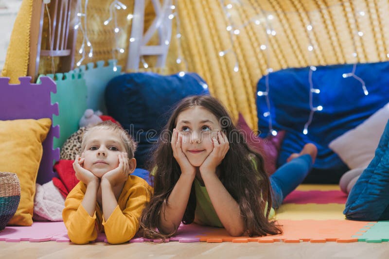 Children play at home with pillows and covered blanket royalty free stock photo