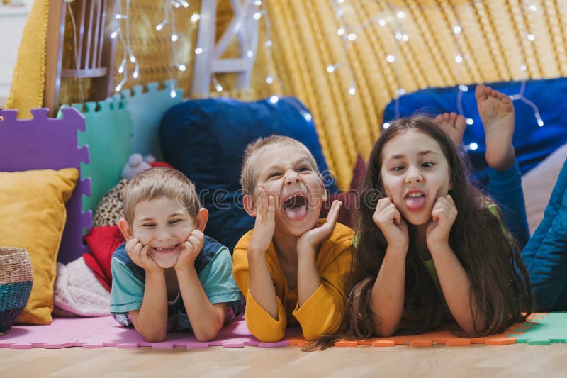 Children play at home with pillows and covered blanket stock image