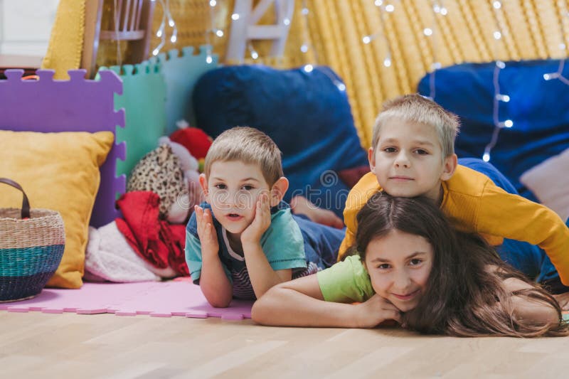 Children play at home with pillows and covered blanket royalty free stock photography