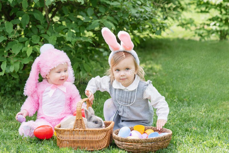 Children play with real rabbit. Laughing child at Easter egg hunt with pet bunny stock photography Children play with real rabbit. Laughing child at Easter egg hunt with pet bunny stock photography