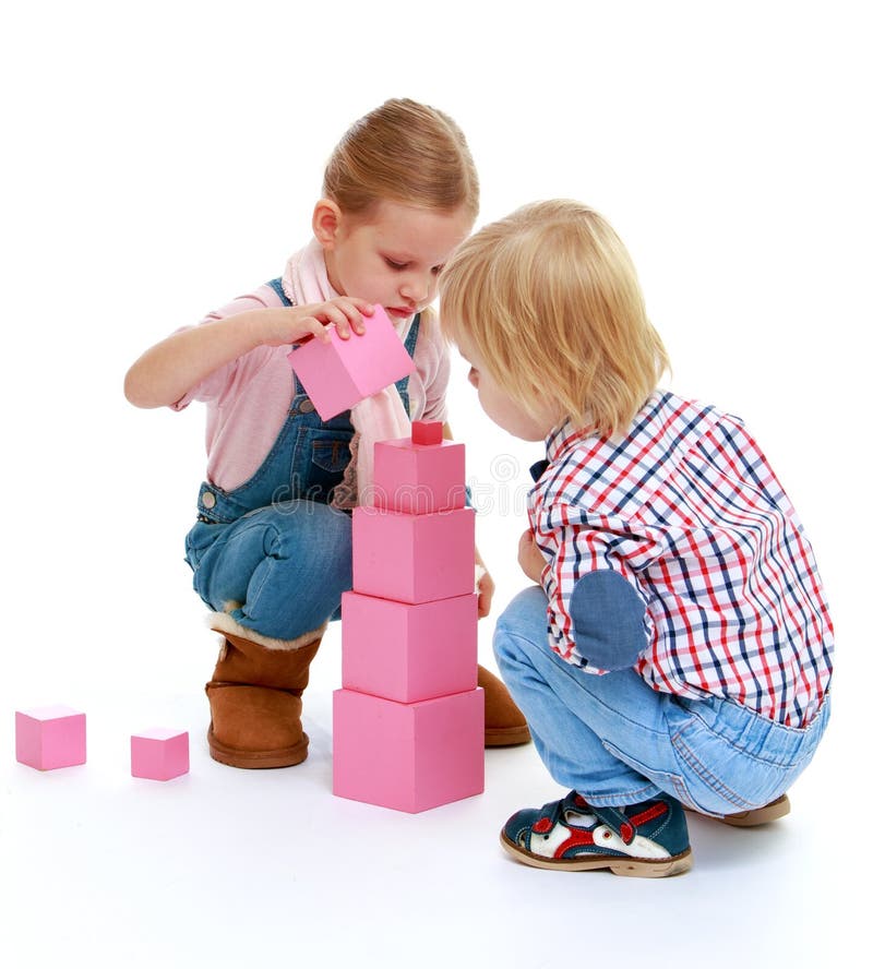 Children playing with blocks.Childhood education development in the Montessori school concept. Isolated on white background.