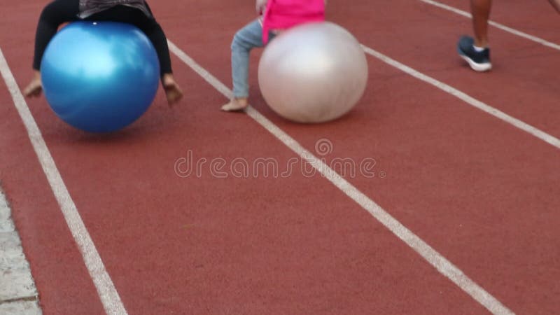 Children Playing Bouncing Ball Jogging Track