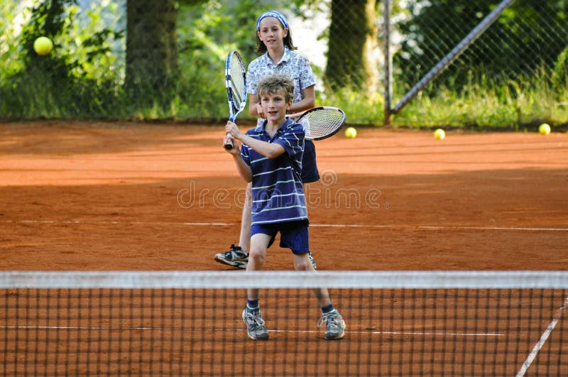 Children playing game of tennis