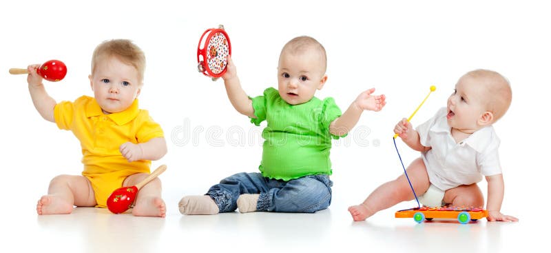 Children playing with musical toys on white background