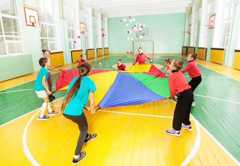 Children playing parachute games in sports hall stock images Children playing parachute games in sports hall stock images