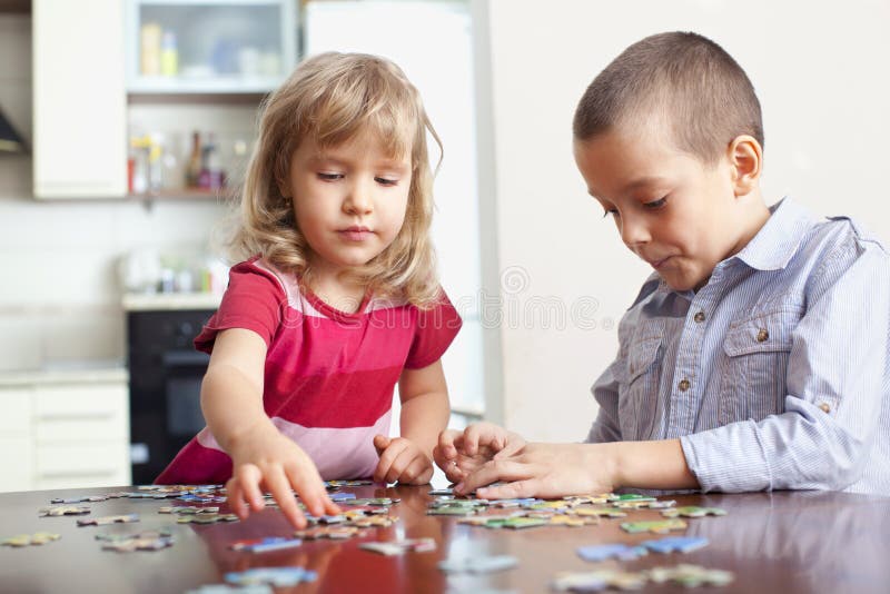 Children, playing puzzles stock photo. Image of preschool - 18717628