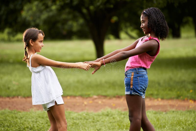 Children Playing Ring Around The Rosie In Park Stock Photo Image Of