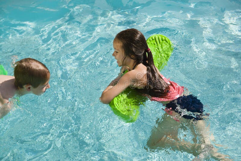 Children Playing In Swimming Pool royalty free stock photos