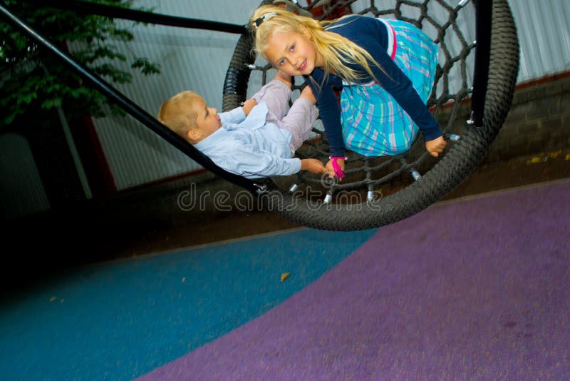 Children ride on a swing stock photo. Image of active 42760034