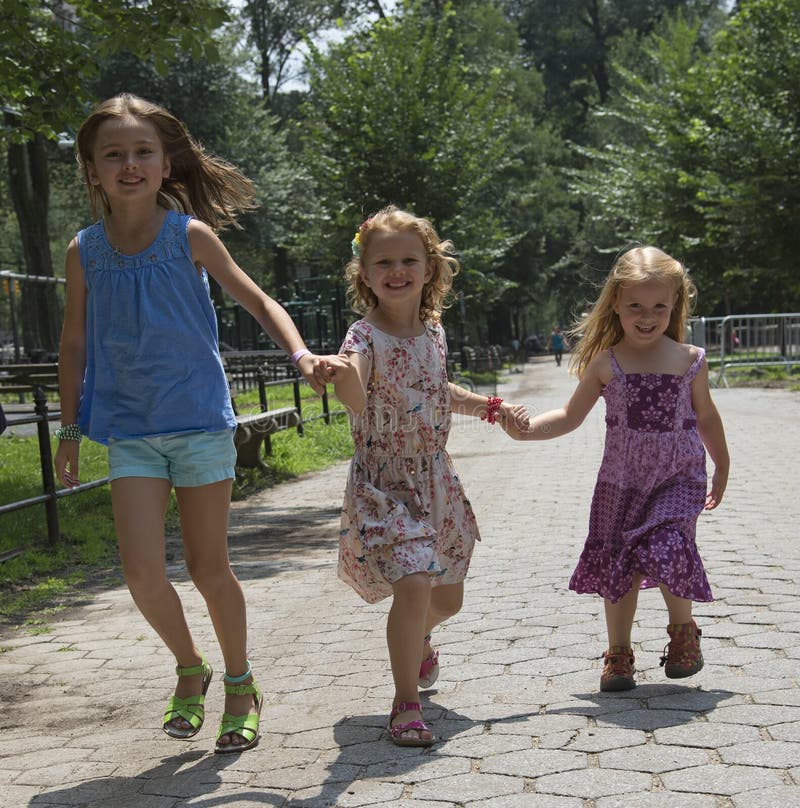 Children running in a Park New York USA