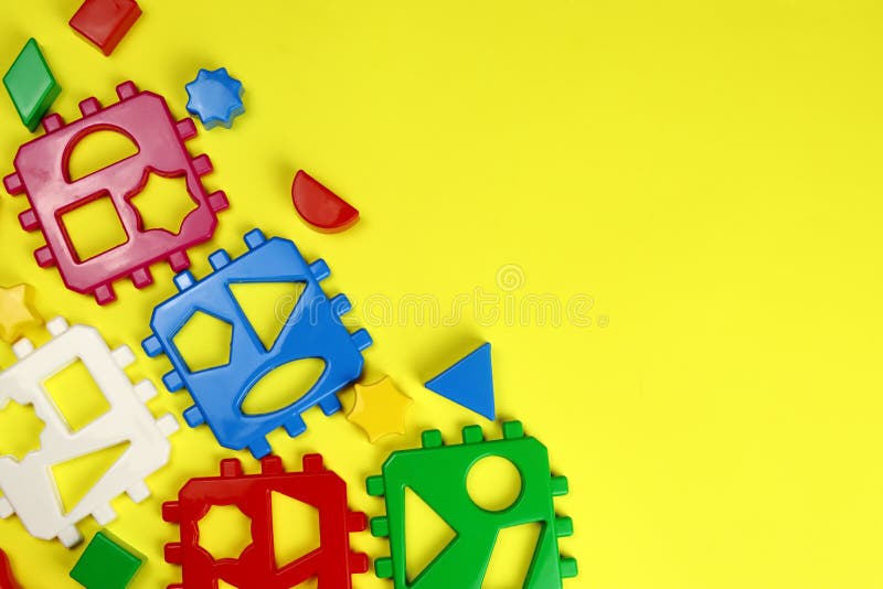 Children&#x27;s bright background of toys on yellow. Copy space for text stock photos
