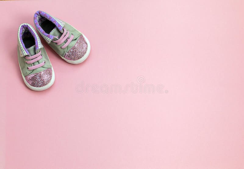 Children`s denim sports shoes for girls, stands on a pink background. stock image Children`s denim sports shoes for girls, stands on a pink background. stock image
