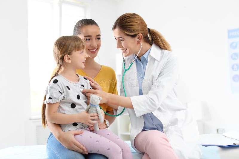 Children`s doctor examining little girl near parent