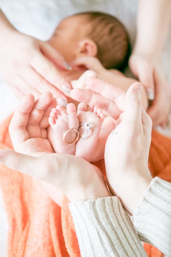 Children`s feet in hands of mother and father. Mother, father and Child. Happy Family concept stock photography Children`s feet in hands of mother and father. Mother, father and Child. Happy Family concept stock photography