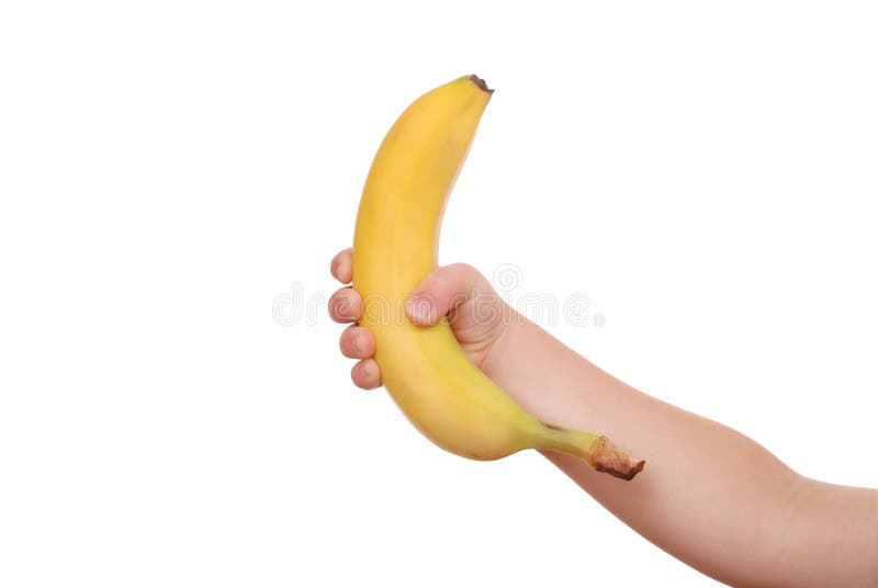 The children s hand holds a banana. 