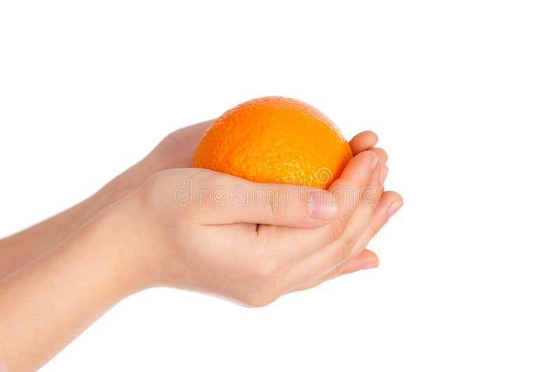 Children s hand with an orange on white