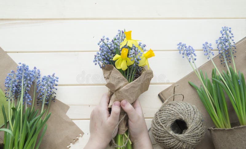 Children`s hands collect a bouquet as a gift. A gift for mom.