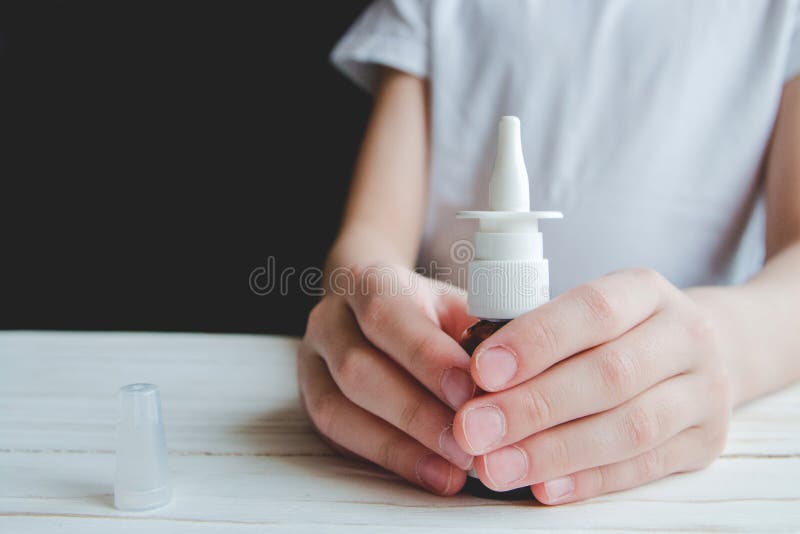 Children`s hands hold the nasal spray stock images Children`s hands hold the nasal spray stock images