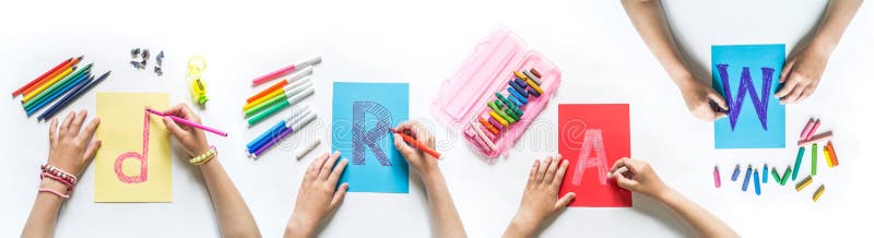 Children`s hands write the word Draw