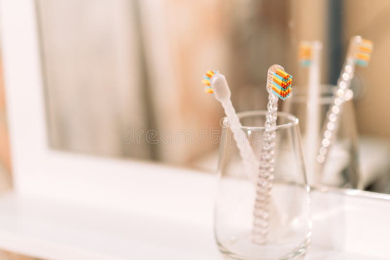 Children S Toothbrushes in Glass Cup in Front of Mirror Stock Image Image of design, oral