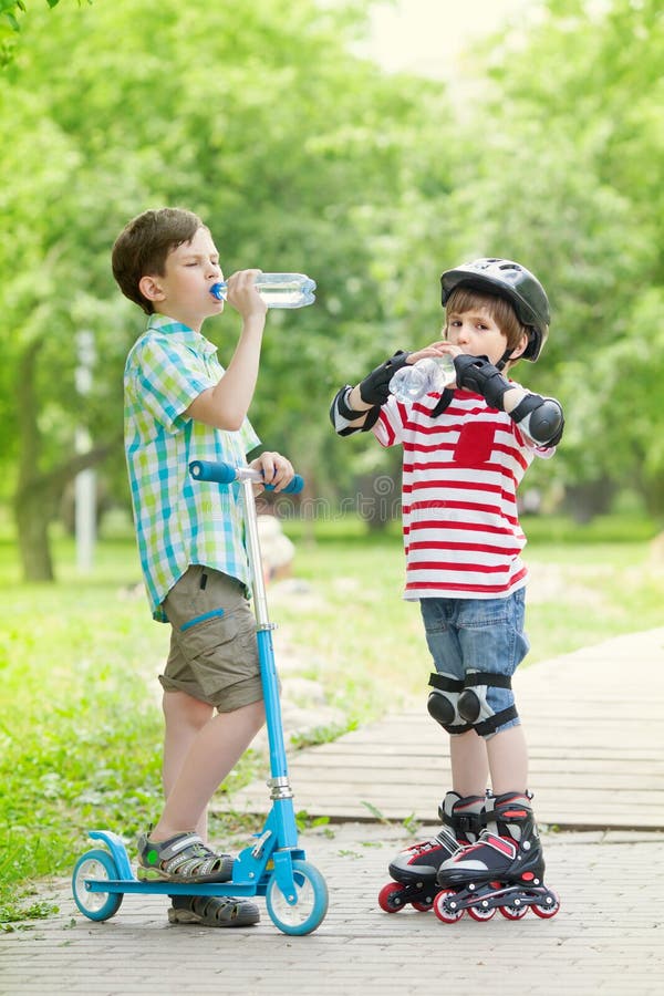 Children with Scooter and Rollers Drink Water Stock Image Image of