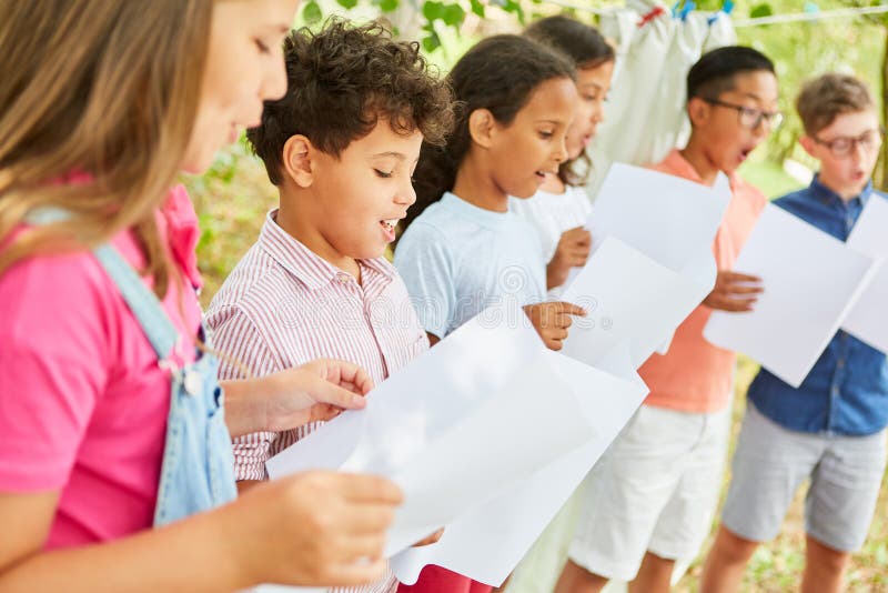 Children sing together in the choir at the summer camp on talent show