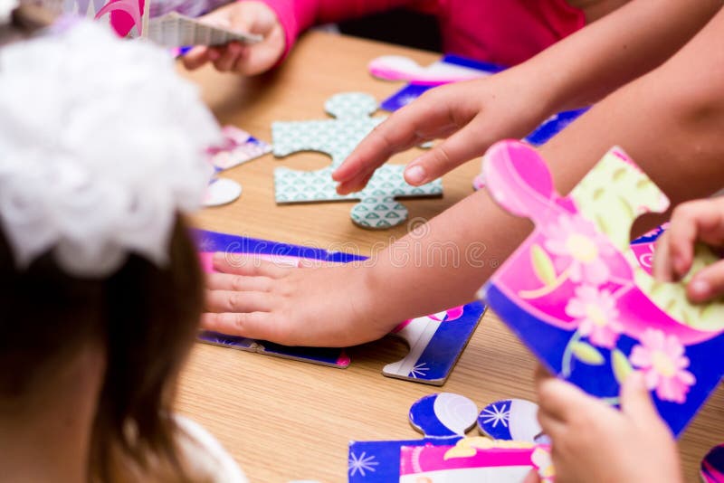Children solving jigsaw puzzle royalty free stock photos Children solving jigsaw puzzle royalty free stock photos