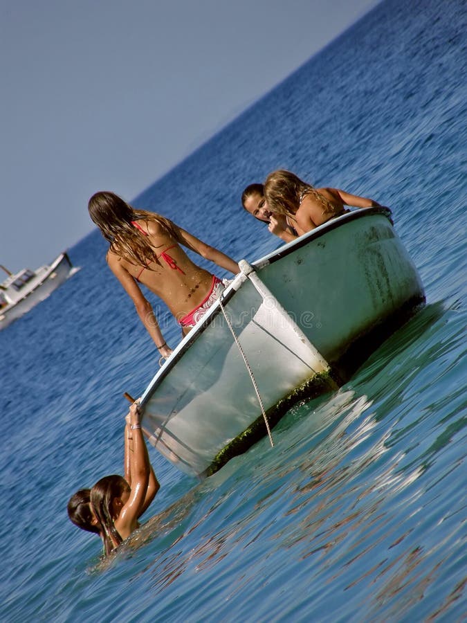 Children in summer fun on boat in sea