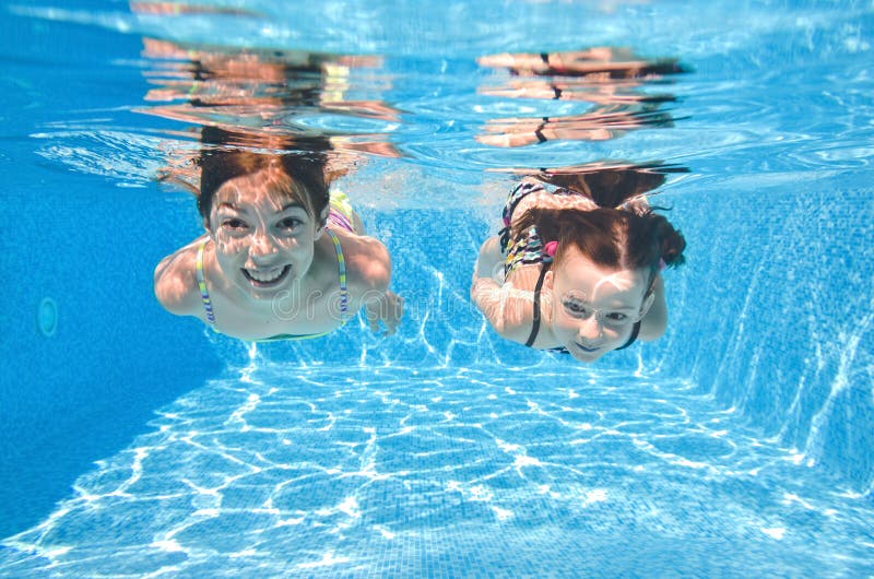 Children Swim In Swimming Pool Underwater Little Active Girls Have Fun