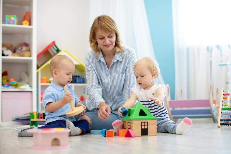 Children with teacher playing with educational toys royalty free stock images Children with teacher playing with educational toys royalty free stock images