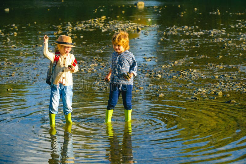 Children Throw Stones at the Stony River. Beautiful Children Throws a ...