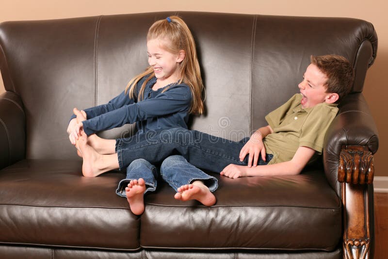 Children tickling feet