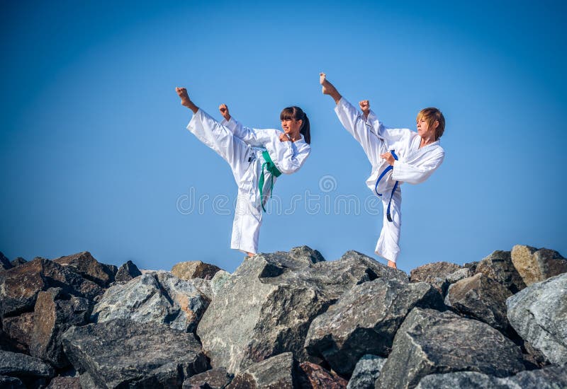 Children training karate on the stone coast stock image Children training karate on the stone coast stock image