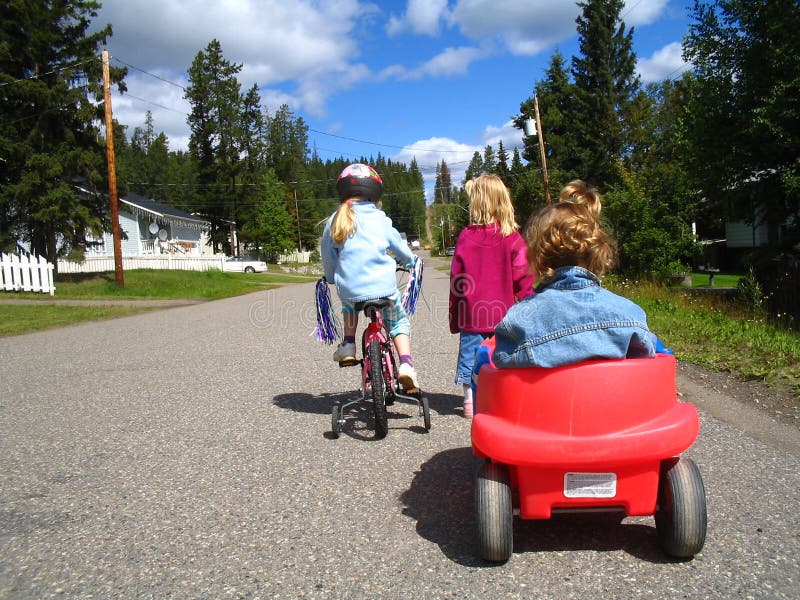 Children with wagon and bike