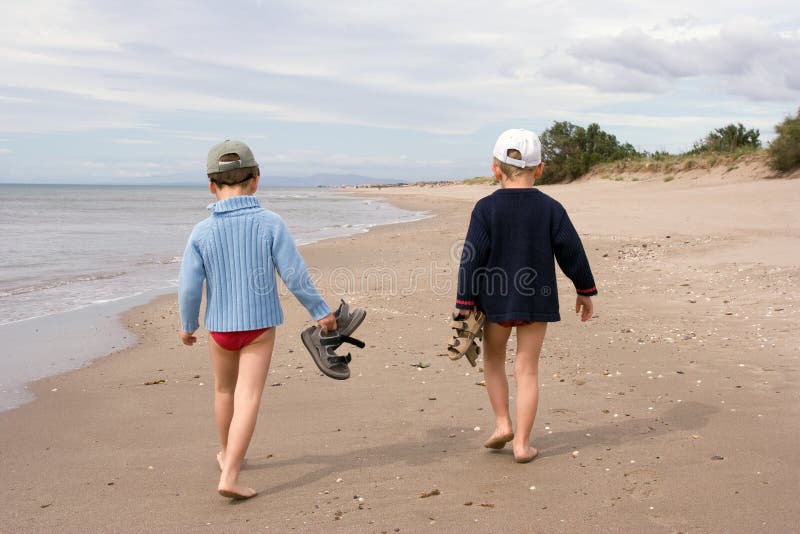 Children walking on the beach