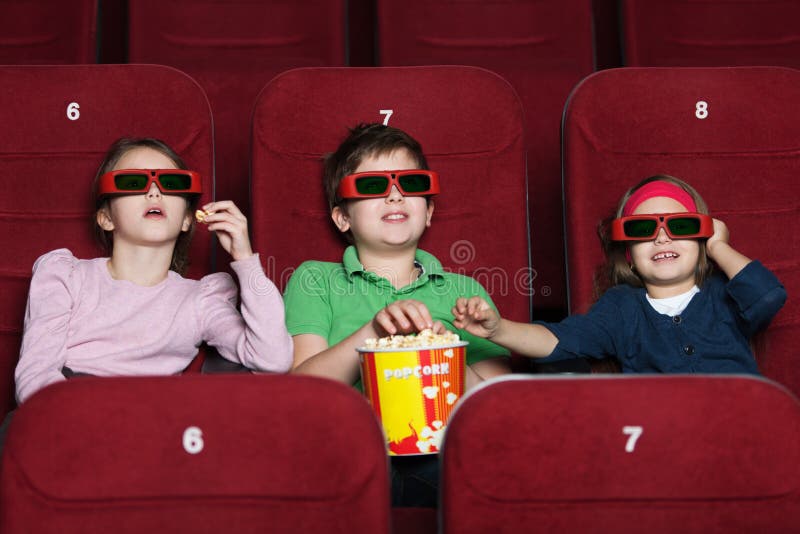 Kids in the movie theater stock photo. Image of friends 24716080