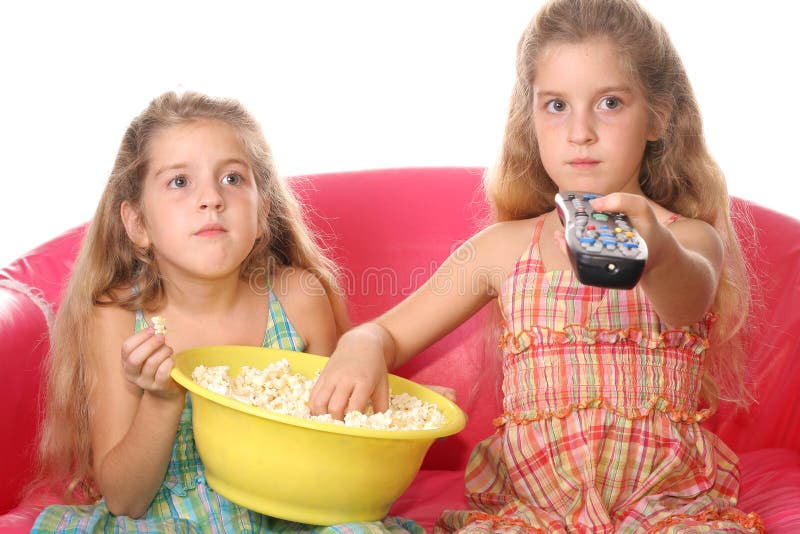 Children watching a movie eati